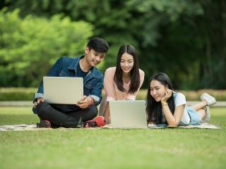 Students discussing on the campus grass